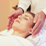 person receiving reiki hands on the outside of their head