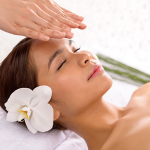 woman with flower in hair receiving reiki healing